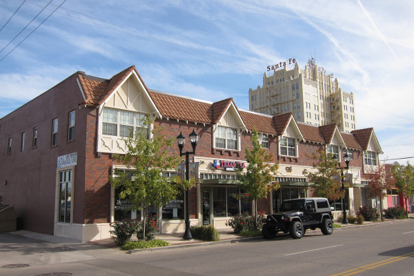 Brick storefronts at 208 SW 10th Avenue in downtown Amarillo, with the Santa Fe Building rising behind them.